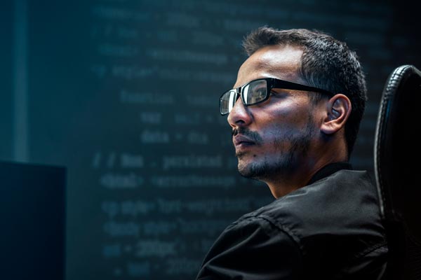 man analysing binary code virtual screen